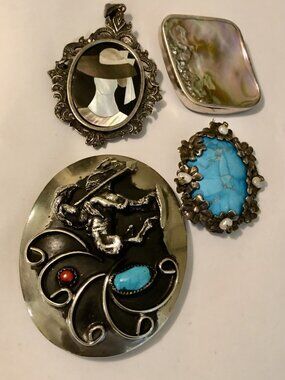 Four vintage, unbranded pins, one large three medium sized, all different styles
